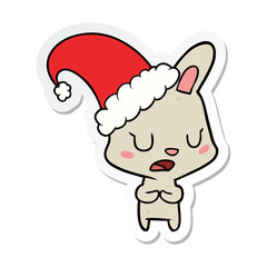 sticker of a cartoon rabbit wearing christmas hat