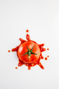 Fallen Smashed Tomato With Ketchup Spot On The White Background