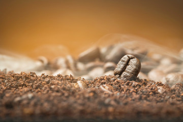 Close up Coffee beans over the cofee powder with smoke