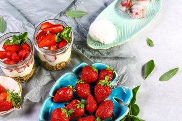 amazing strawberry cheesecake mousse cups decorated by homemade ice cream and mint leaves. Copy space