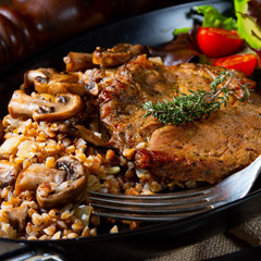Pork steak with mushrooms and buckwheat groats and mango salad