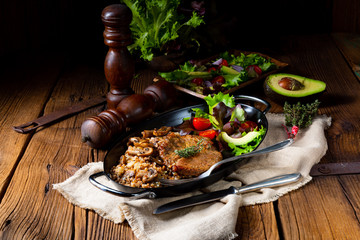 Pork steak with mushrooms and buckwheat groats and mango salad