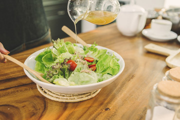 man makes a salad in the morning in the kitchen