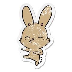 Obraz premium distressed sticker of a curious bunny cartoon