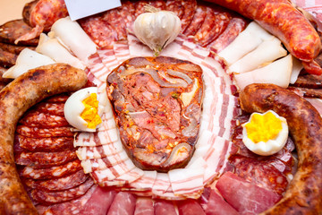 Traditional sausages are arranged with various smoked meat for review at food contest