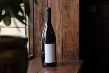Foto op Plexiglas Bottle of red wine on wooden background. Blank Label for your text or logo. Mock up © skvalval