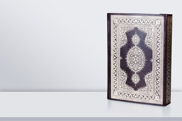 Islamic Book Koran with rosary on background