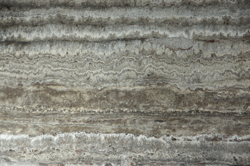 Natural stone travertine gray-beige and parallel stripes is called Travertino Titanium