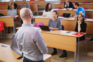 Lecturer and multinational group of students in an auditorium