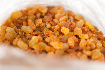 Delicious yellow raisins, highest grade. Delicious and beautiful background or wallpaper, selective focus, top view