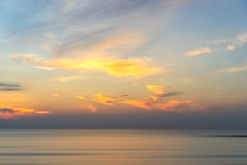 Naklejka na ściany i meble Background of colorful sky morning time. Sunrise on the beach and sea.