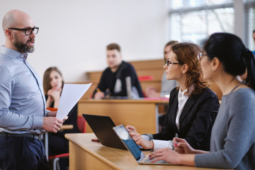 Lecturer and multinational group of students in an auditorium