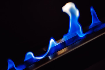 Blue flames of a gas stove fireplace