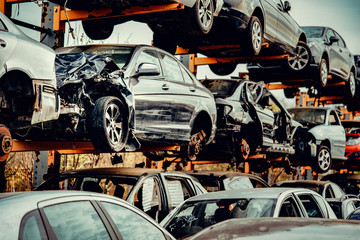 Damaged cars waiting in a scrapyard to be recycled or used for spare parts
