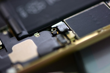 technician repairing broken mobile phone close-up.Close-up Of A Human Hand Repairing Smartphone With Screwdriver Internal circuits and structural elements of mobile phones