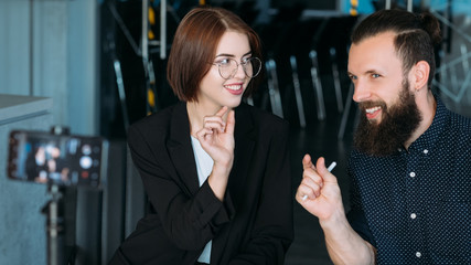 Business workshop. Leadership coaching. Man and woman shooting master class. Mobile video.