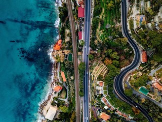 Aerial view of road, highway and railway going along ocean or sea. Drone photography in rural Italy