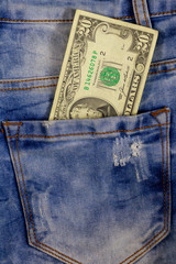 Twenty dollars bill in the pocket of blue jeans