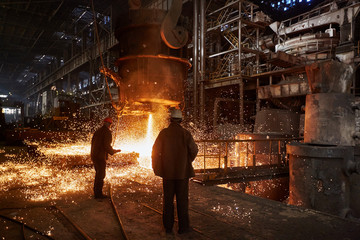 Metallurgists at casting ingots