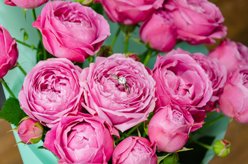 ring in a flower bouquet with pink roses