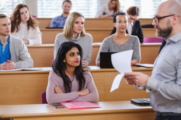 Lecturer and multinational group of students in an auditorium