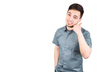 young man answering smartphone over white background. A man is talking on the phone
