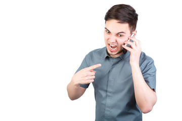 young man answering smartphone over white background. A man is talking on the phone