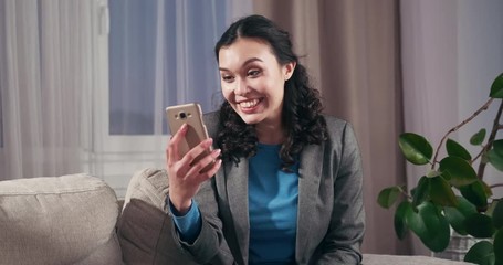 Happy businesswoman talking through video calling on mobile phone