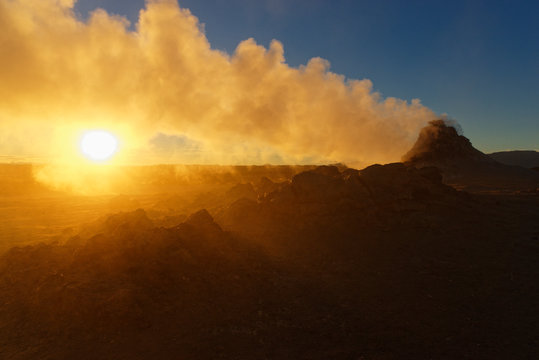 Sonne scheint durch den Schwefeldampf eines Fumarols, Geothermalgebiet Hverir, Island