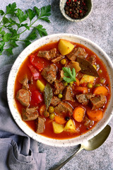 Meat stew with vegetables in tomato sauce.Top view with copy space.