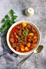 Meat stew with vegetables in tomato sauce.Top view with copy space.