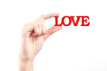 Female hand isolated on white background. White woman's hand showing symbols and gestures. Wooden red inscription love. Love