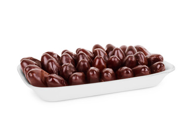 Dates in a bowl with a mint leaf isolated on white background
