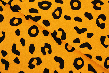 Cotton fabric with animal print. Animal pattern background or texture. Texture leopard.