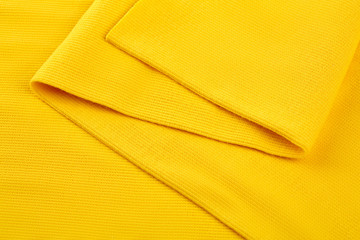 Yellow cotton textile - close up of fabric texture. Cotton Fabric Texture. Top View of Cloth Textile Surface. Yellow Clothing Background. Text Space. Abstract background and texture for designers.