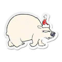 distressed sticker cartoon of a angry polar bear wearing santa hat