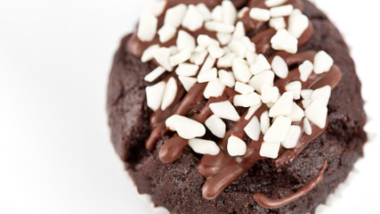 Tasty chocolate cupcakes on white background. Chocolate caramel cupcake and butterscotch syrup. Chocolate cupcake isolated on white.