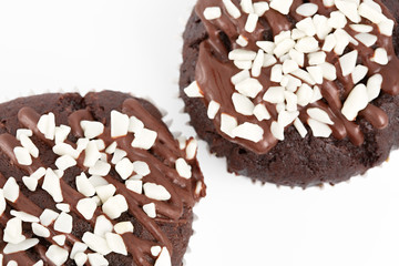 Tasty chocolate cupcakes on white background. Chocolate caramel cupcake and butterscotch syrup. Chocolate cupcake isolated on white.