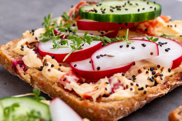 Sandwiches with cream cheese, vegetables and salami.