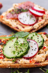 Sandwiches with cream cheese, vegetables and salami.