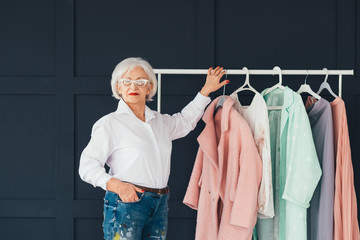 Smart senior lady wardrobe. Shopping leisure. Personal style of wealthy elderly woman.