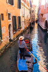 Fototapeta na wymiar Canal with gondolas in Venice in a sunny day