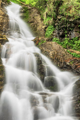 Fototapeta na wymiar Natural waterfall Patraitesti Long exposure shot with ND -filter