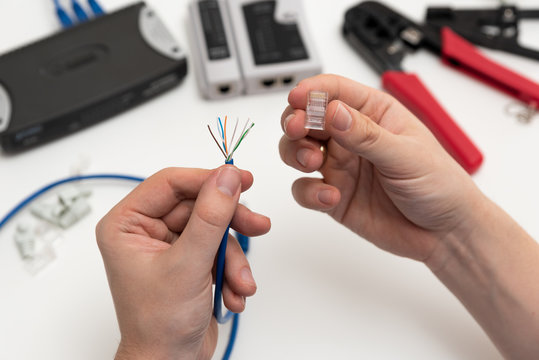 Technician holding twisted pair internet cable