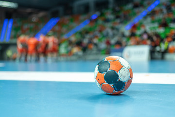 The ball on the parquet during time in handball match. - obrazy, fototapety, plakaty