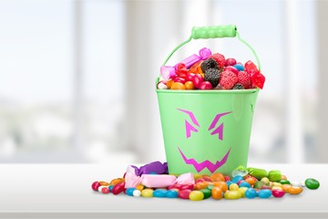 Transparent glass jar with colorful chocolate candies