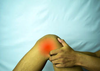 suffering from joint pain with red spot. Hands on leg as hurt from Arthritis. Osteoarthritis knee disease concept