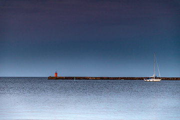 pier and lighthouse on sea
