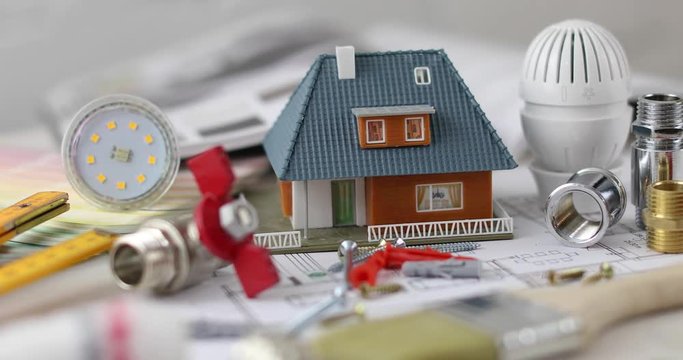 house construction project - tools and equipment with scale model
