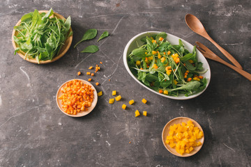 Fresh organic micro greens with carrot diced, food closeup